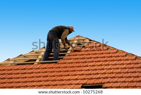 construction workers reapiring roof