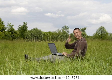 man working on laptop in nature outdoor