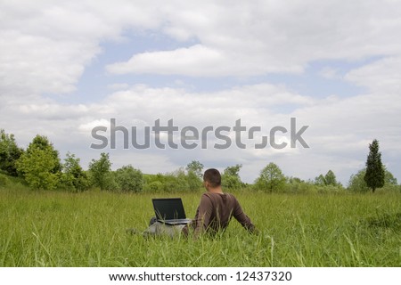 man working on laptop in nature outdoor