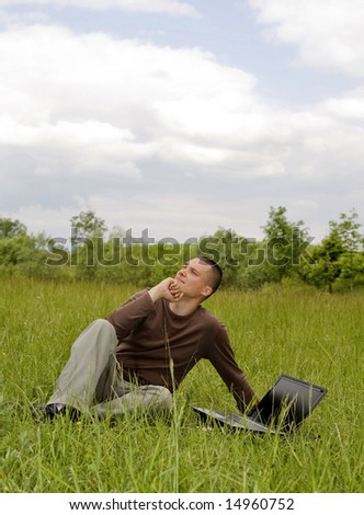 man workng on laptop in nature outdoor