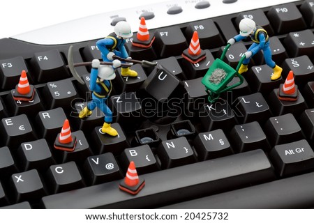 computer repair concept - workers repairing keyboard