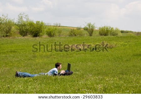 man with laptop outside working