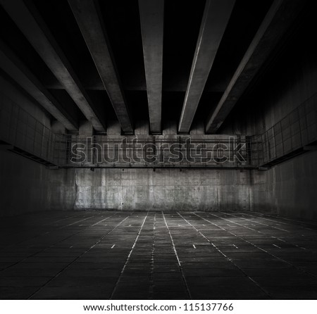 Dark stone and concrete space with tiled floor and ceiling of concrete beams.