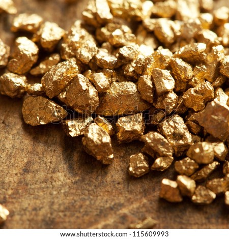 A Mound Of Gold On A Old Wooden Work Table