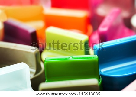 Colorful lids of paint often used in plastic model building.