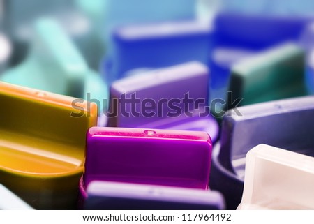 Blue and purple colorful lids of paint often used in plastic model building.