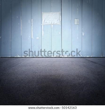 Blue grungy construction wall with blank paper sign