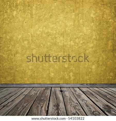 Gold grungy room with worn wooden flooring. Focus on the foreground.