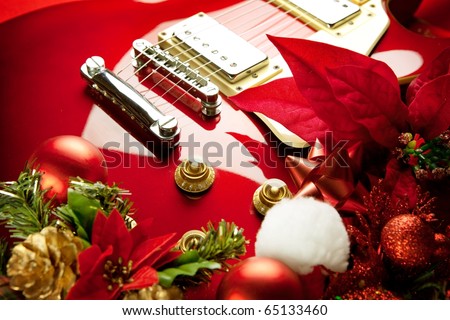 Red electric guitar with christmas ornaments. Concept image for christmas / holiday season music event, or musical instrument for christmas present.