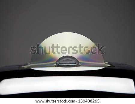 Toasting or burning a DVD or a CD-R disc. An optical disc popping out from a pop-up toaster.