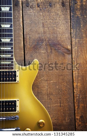 Vintage Gold top guitar on old wood surface.