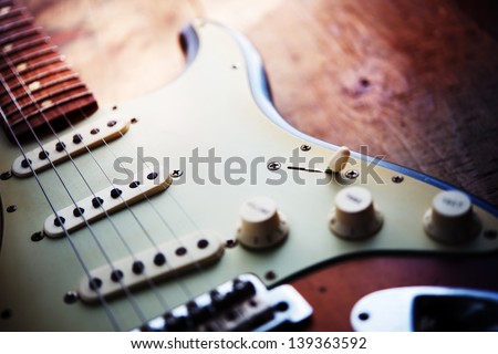Electric guitar  on a grungy old wooden surface with impressional feeling.