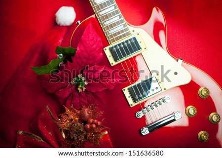 Red electric guitar with christmas ornaments. Concept image for christmas / holiday season music event, or musical instrument for Christmas present.