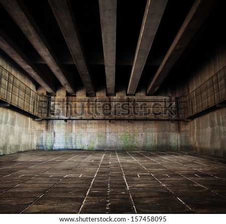 Concrete space with tiled floor and ceiling of concrete beams.
