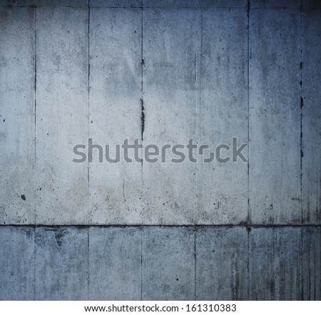 Grungy concrete wall with lower section in darker tone.