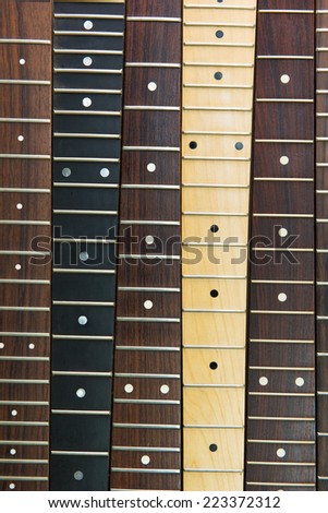 Six guitar necks aligned, Rosewood, maple and ebony fingerboard necks