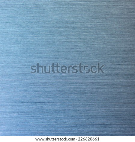 Photo of a real brushed metal texture,  in blue light.