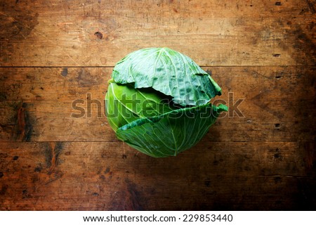 Fresh harvested cabbage, on a old grungy table. Vegetables with artistic impression