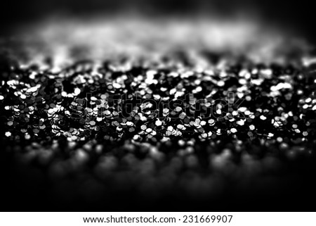 Abstract black glitter background, shallow depth of field.