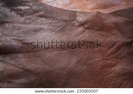 Processed raw hide or leather placed on leather working table. (not a texture shot, has depth)