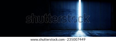 opening a heavy steel door. Large steel doors of an hanger like building opening and light coming in. with plenty of copy space