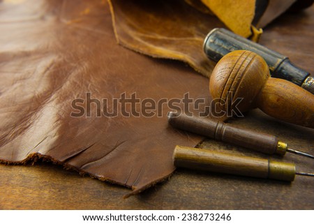 Leather craft. Leather and leather crafting tools on a work table.