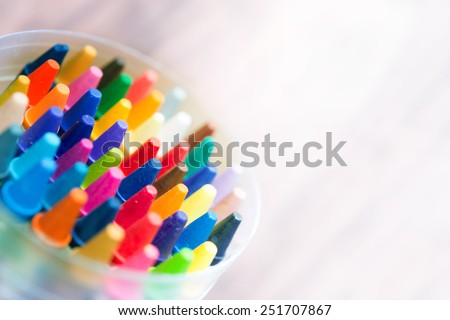 Crayon abstract. Vivid and strong colored crayons fading into bright white light.