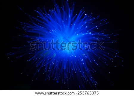 Optical fiber (light fiber) abstract. Blue glow of optical fiber in a spherical shape . shallow depth of field.