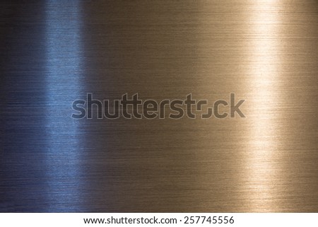 Brushed metal with blue cool light and orange warm light reflection.