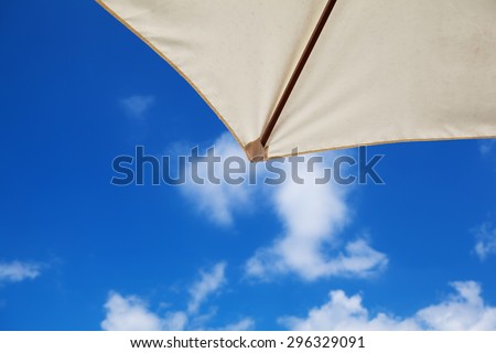 Summer sky. Sunny summer blue sky seen from under a beach parasol.