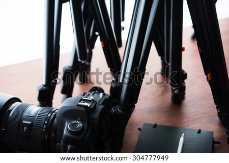 Tripods and Digital camera (DSLR) . Ready for filming or photo session. Photography equipment.
