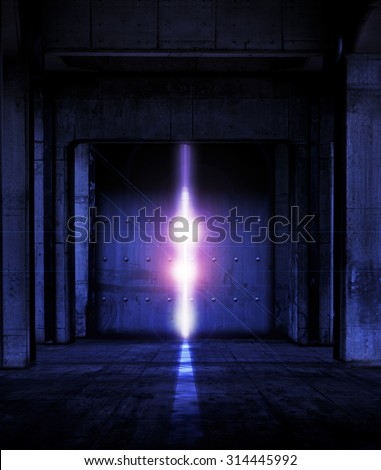 Heavy steel doors opening. Large steel doors at the end of a dark corridor, opening and light coming in.