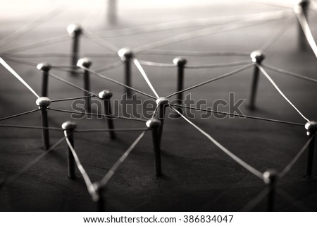 Linking entities. Network, networking, social media, internet communication abstract. Web of wires on wood. Monotone or Black and White.