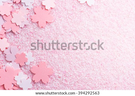 Cherry blossom background image. Cherry blossom pastel pink abstract background fading in to white. Sakura or cherry flower shaped paper cutouts on pink background.