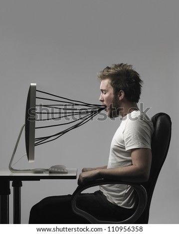 A man connected to a computer with wires.