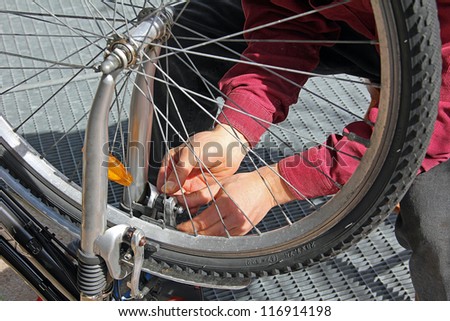closeup of a man, doing bicycle repairs and maintenance