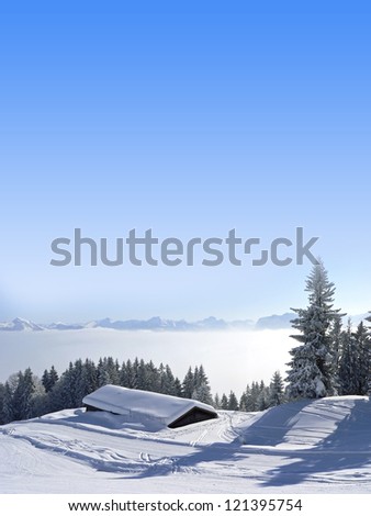 winter landscape with alpine cabin on a foggy morning, blue sky with free space, austria landscape