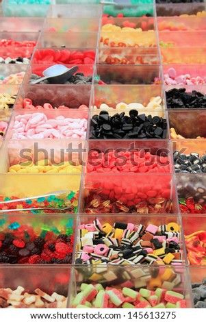 assortment of candies in transparent boxes at the market