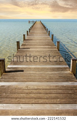 boardwalk to the endless horizon and open sea. Morning mood at sunrise