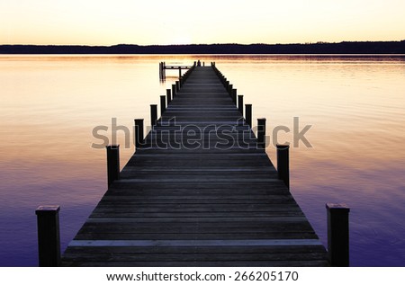 romantic scenery at starnberg lake, with boardwalk at sunset