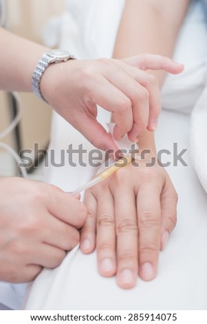 Nurse removing iv needle with selective focus