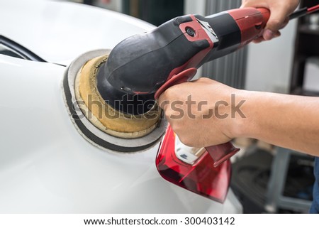 Car polishing series : Worker waxing white car