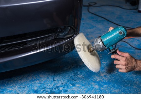 Car polishing series : A man waxing blue car