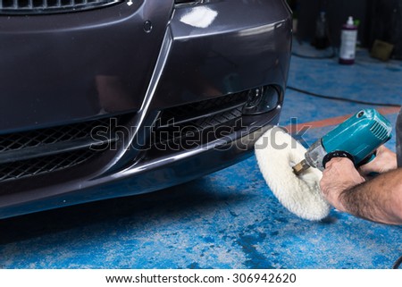 Car polishing series : A man waxing blue car