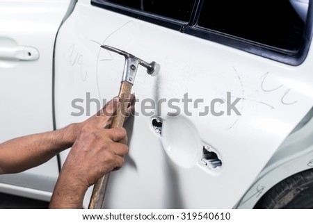 Car paint repair series : Worker repairs white car paint