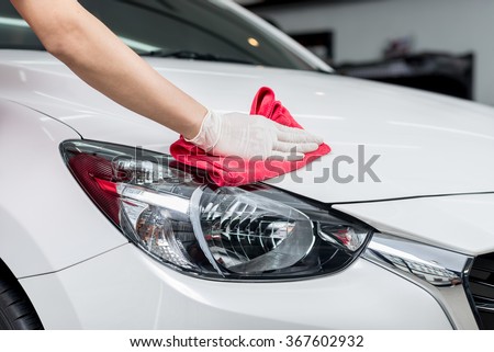 Car detailing series : Worker cleaning  white car