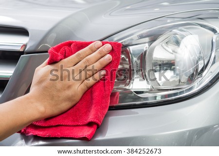 Car detailing series : Worker cleaning gray car