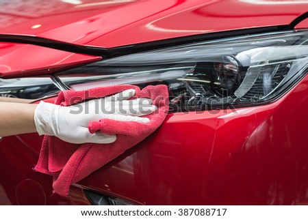Car detailing series : Worker cleaning red car