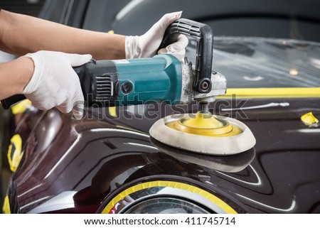 Car detailing series : Worker polishing brown car