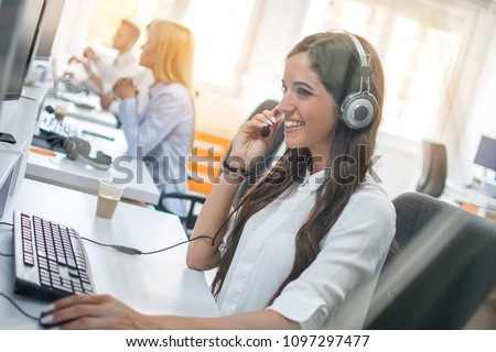 Customer service operator woman with headset working on computer at office
